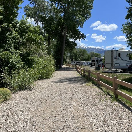 Upgraded premium RV sites with outdoor dining, seating, and propane fire grills for the ultimate camping experience at Riverside RV Luxury Resort in South Weber, Utah.