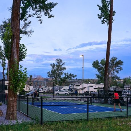 Picturesque outdoor recreational areas within the resort, such as walking trails, picnic spots, and playgrounds at Riverside RV Luxury Resort in South Weber, Utah.