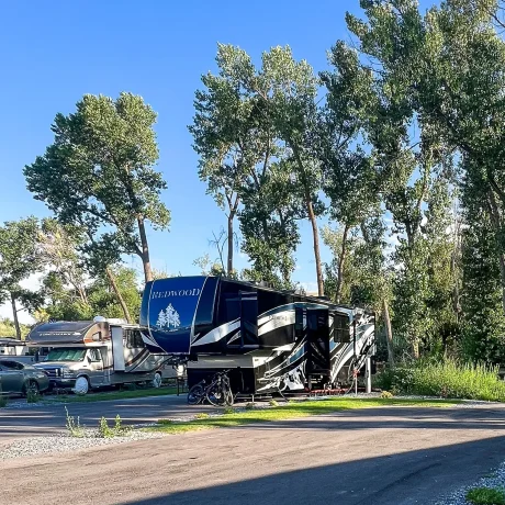 Upgraded premium RV sites with outdoor dining, seating, and propane fire grills for the ultimate camping experience at Riverside RV Luxury Resort in South Weber, Utah.